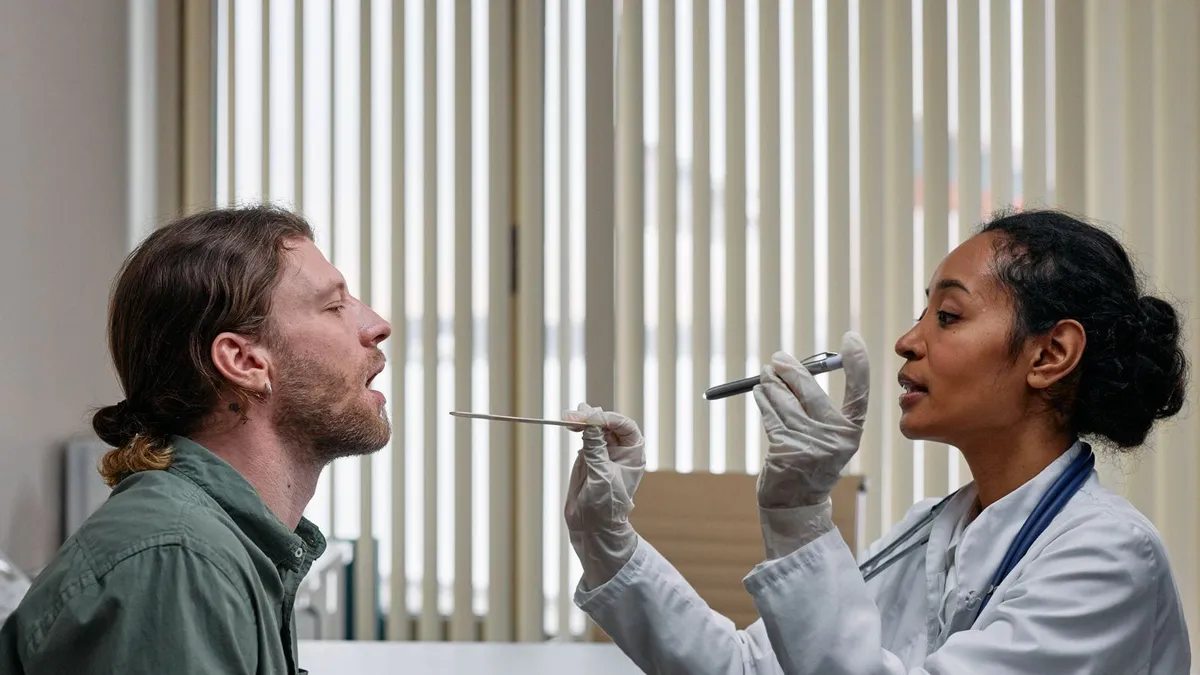 A KEL Healthcare clinician taking a throat swab during a same-day acute care visit
