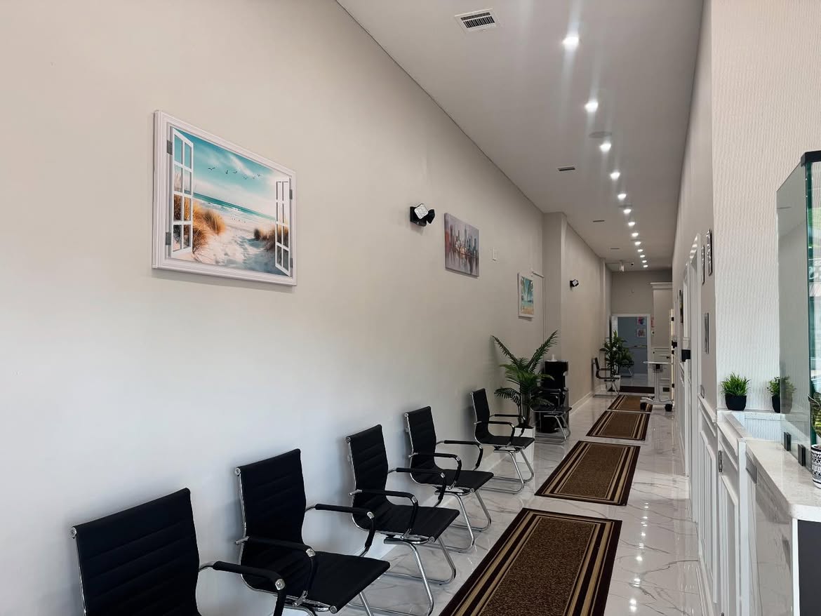 The Woodside waiting area, with a row of seats along the wall and the reception window beyond.